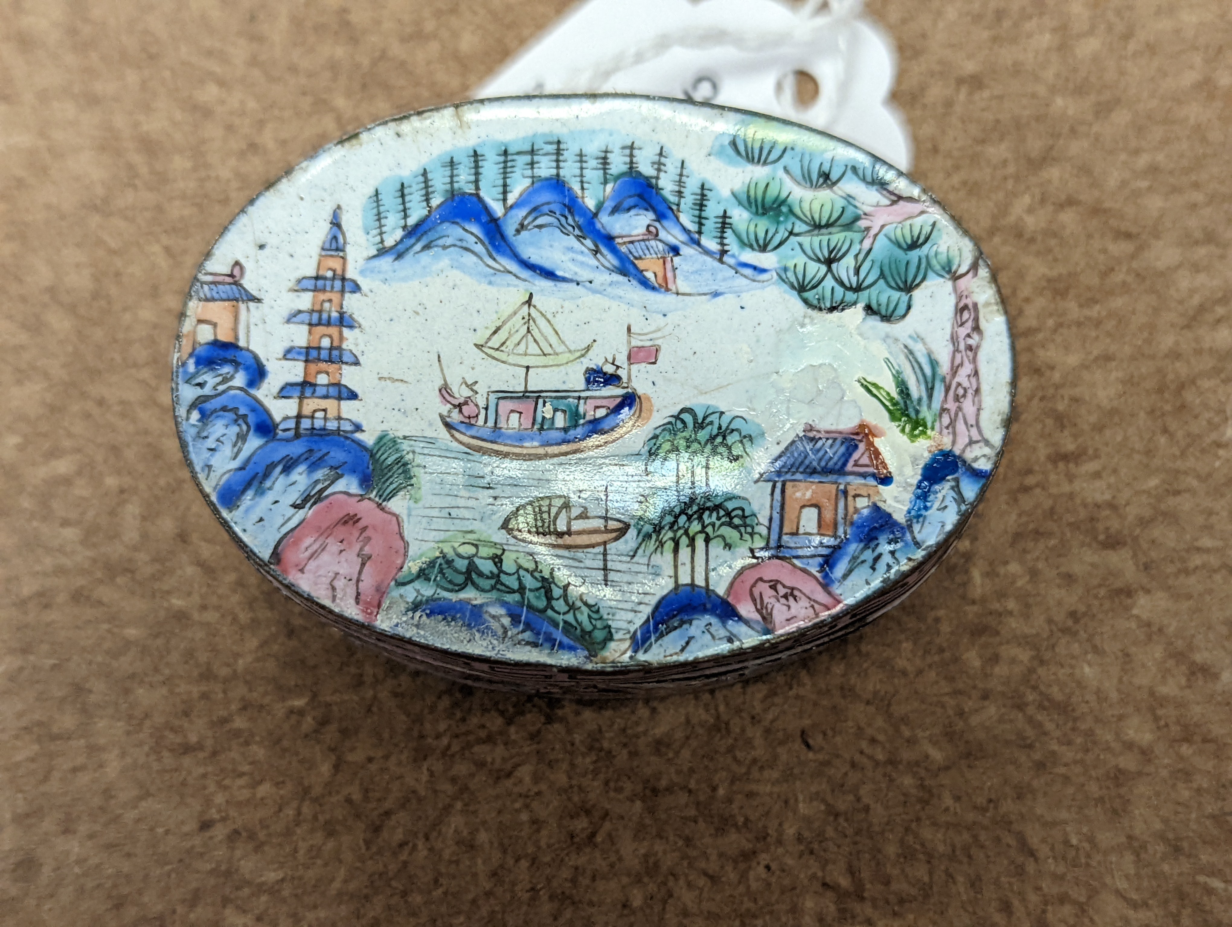 Two 18th century Chinese Canton enamel cups, and a 19th century Canton enamel oval snuff box, 5.8cm